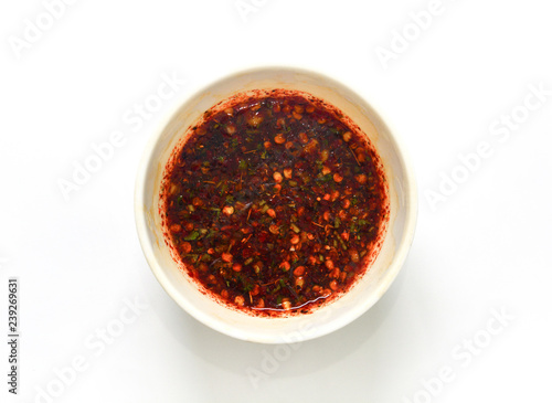 Thai style dipping spicy sauce for roasted or grilled food (fish sauce and chilli) or Nam Jim Jaew on white background, clipping path photo