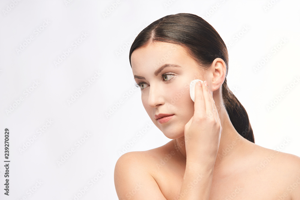 Home face care. Girl remove makeup. Woman hand with pad. Skin clean with cotton Home face care. Girl remove makeup. Woman hand with pad. Skin clean with cotton