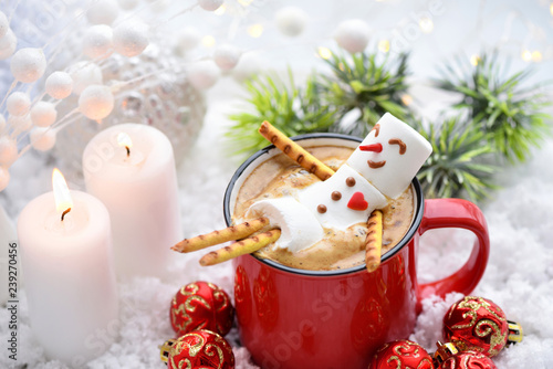 Red mug with cappuccino with melted marshmallow snowman