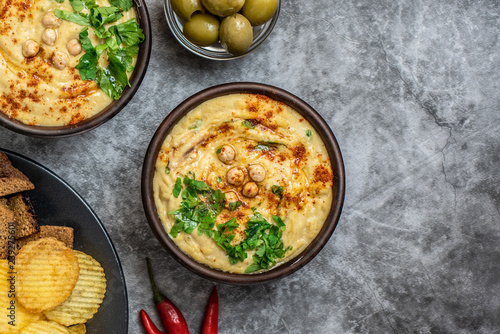Classic hummus in bowls on a grey background. With copy space. Top view