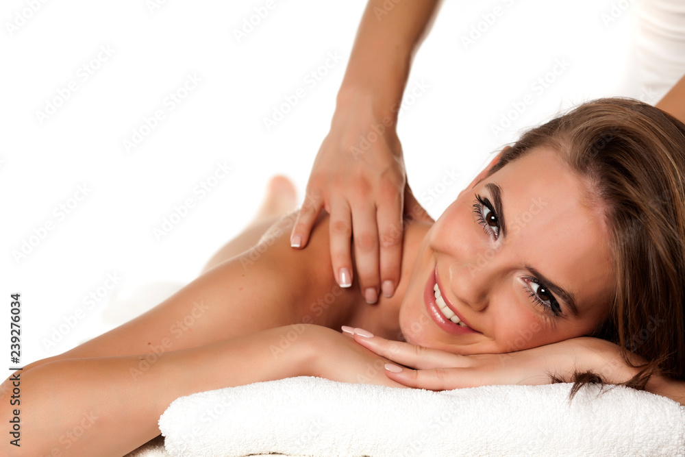 a young smiling woman enjoys the masses of her back a young smiling woman enjoys the masses of her back