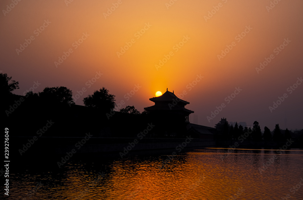 Sunset on the Forbidden city with reflection in the water - Beijing, China
