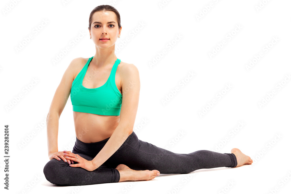 Young beautiful yoga woman is posing in studio on white background Young beautiful yoga woman is posing in studio on white background