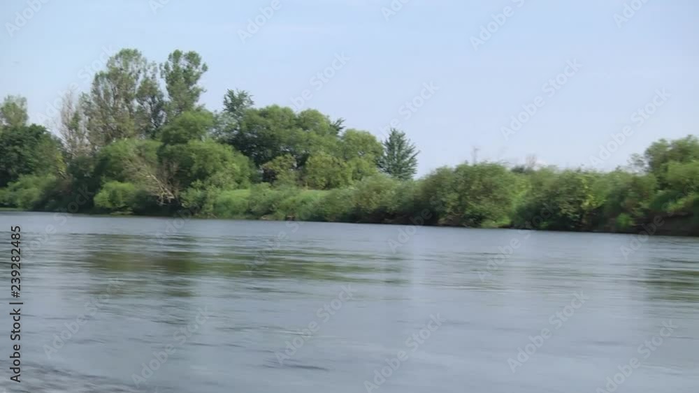 Riding on a speedboat on the river. Beautiful large blue sky overlooking the vegetation. Motor boat sails along the river. Riding on a speedboat on the river. Beautiful large blue sky overlooking the vegetation. Motor boat sails along the river.