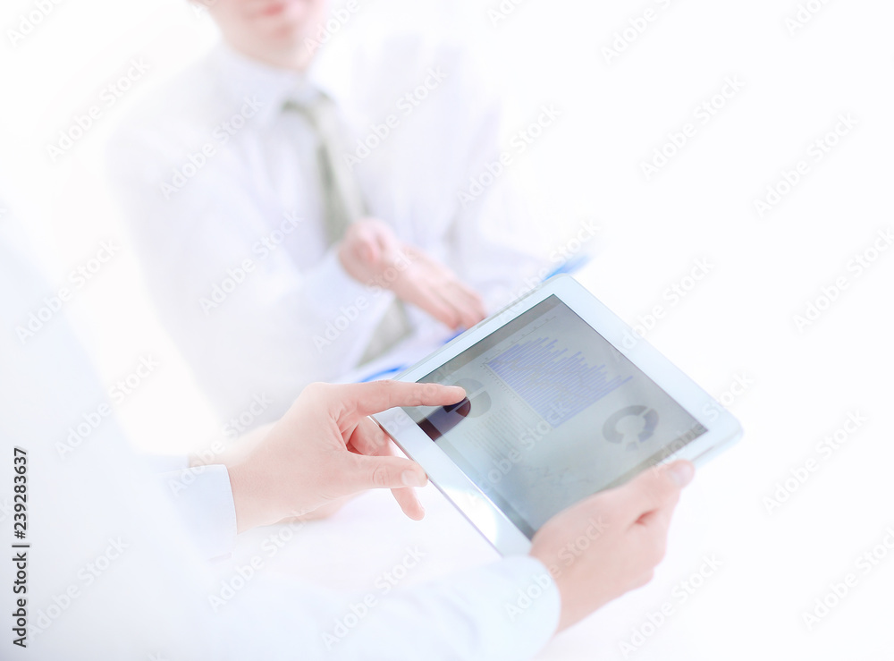 close up.two office workers discussing a financial report. close up.two office workers discussing a financial report.