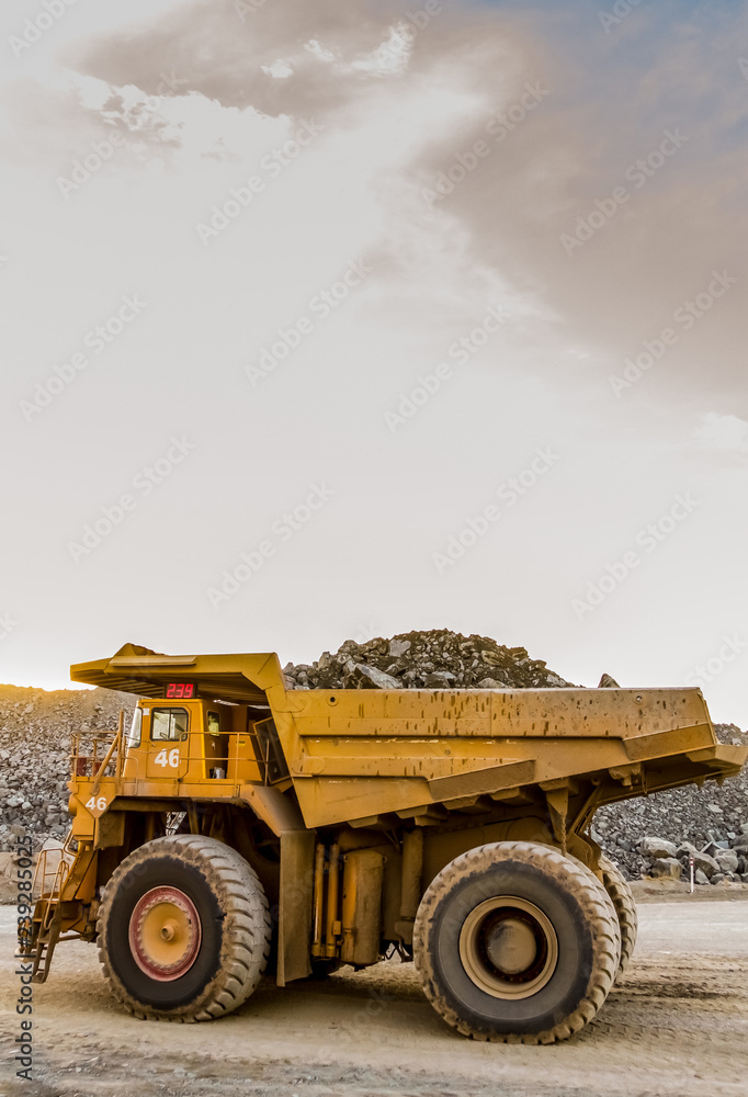 Obraz premium Mining dump trucks transporting Platinum ore for processing