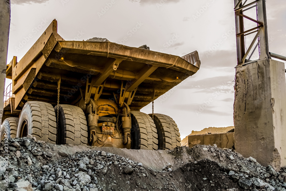 Fototapeta premium Mining dump trucks transporting Platinum ore for processing