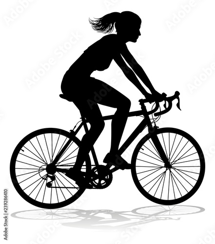 A woman bicycle riding bike cyclist in silhouette