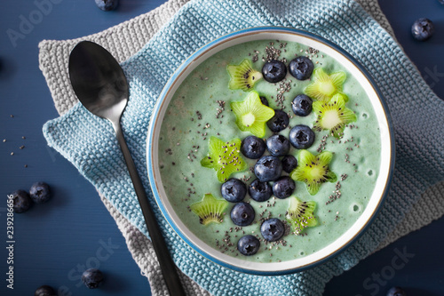 healthy spirulina smoothie bowl with blueberry, kiwi stars, chia seed