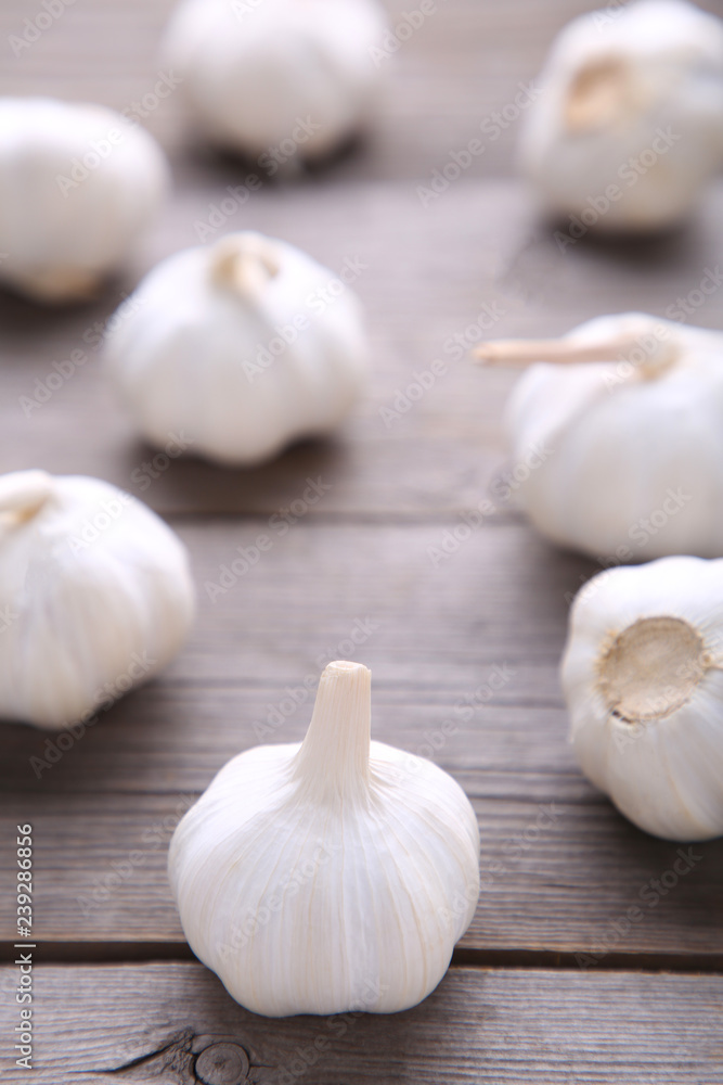 Fresh garlic on a grey wooden background Fresh garlic on a grey wooden background
