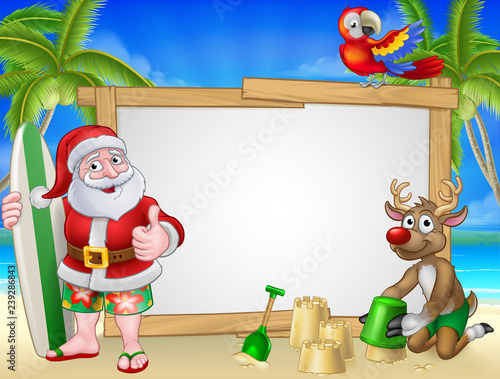 Santa Claus in shorts and flip flops with his reindeer holding a surfboard on a tropical beach with palm trees and parrot Christmas cartoon sign background.