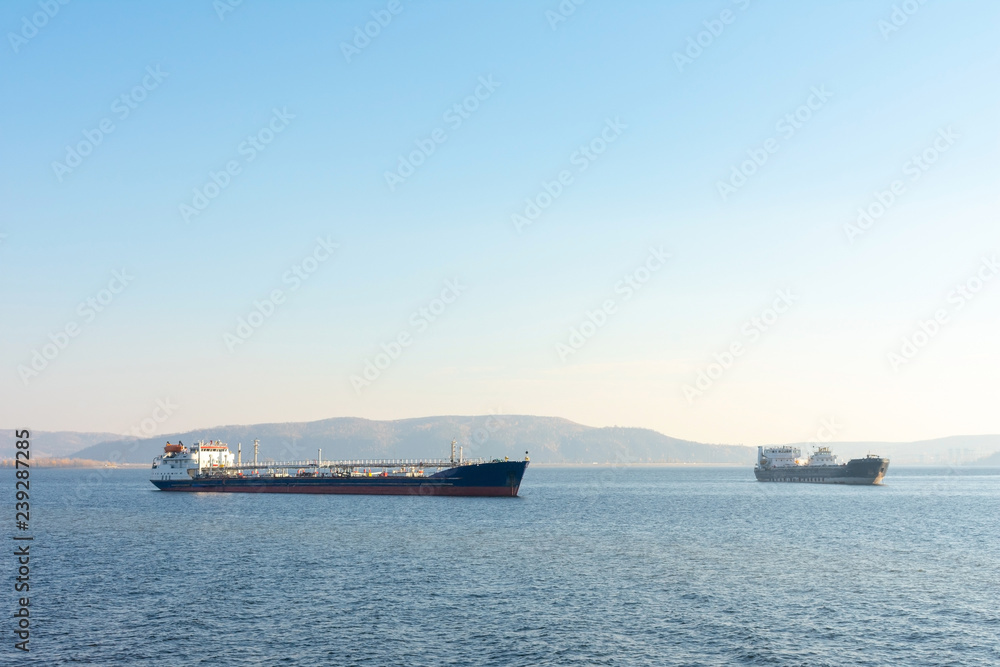 Cargo ship on the background of mountains.