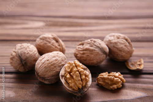 Walnuts kernels on brown wooden background. Walnut healthy food