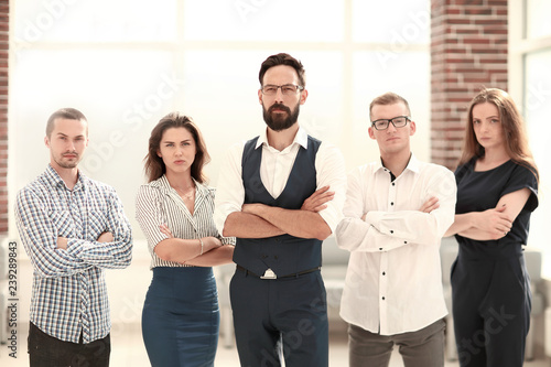 confident business team standing in a modern office