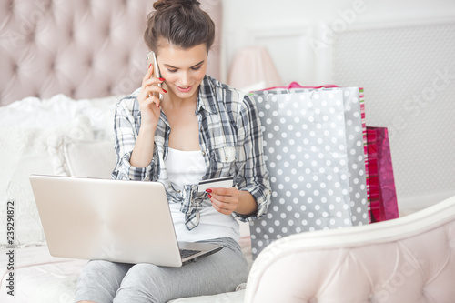 Young woman woking at the computer at home. Female typing. Freelancer working at laptop. Distant job. photo