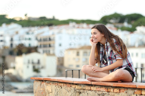 Pensive teen contemplating hozizon in a town