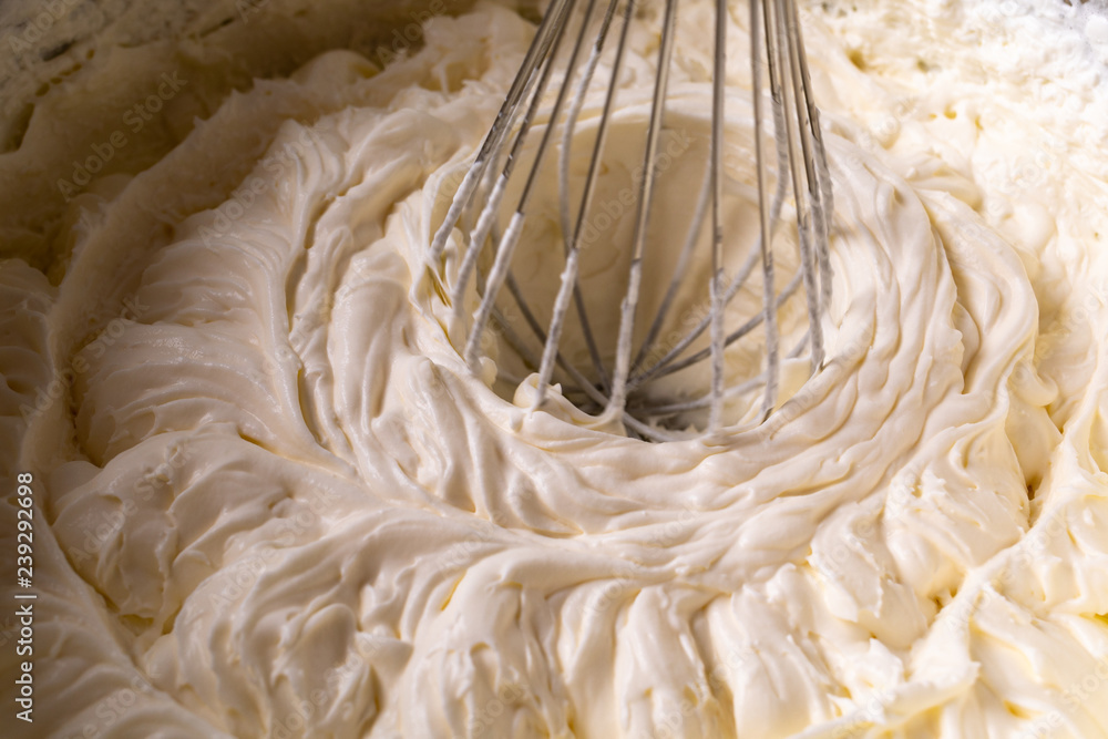Cake cream. Whipped cream. Cream texture. Buttercream texture on top. Whipping the cream with a