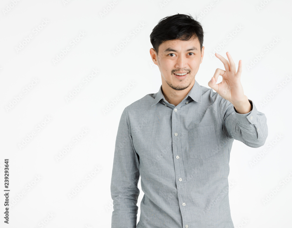 Young man makes okay hand sign. Young man makes okay hand sign.