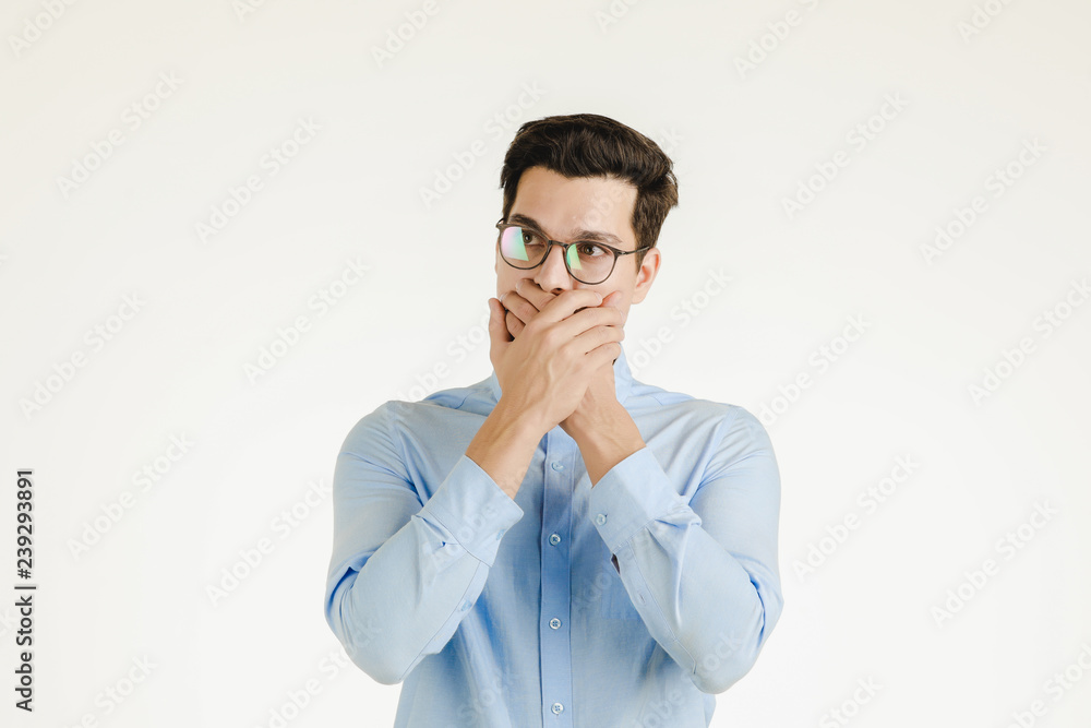Hipster office covering his mout by hands. Hipster office covering his mout by hands.