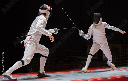 Two man fencing athletes fight Fototapeta