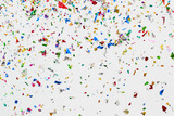 colorful glitter and confetti on white background