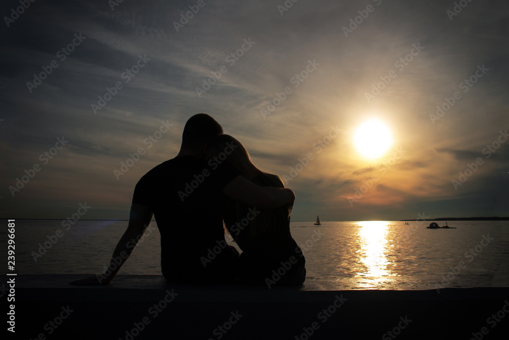 Hugging couple in love silhouette during sunset - Image