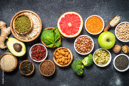 Superfoods on black stone background. 