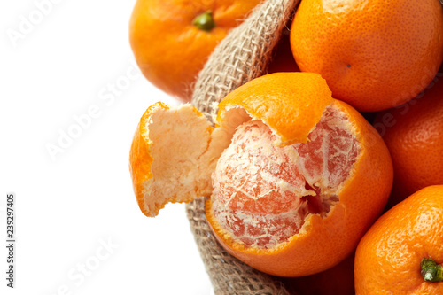 Mandarin orange (Citrus reticulata) also known as the mandarin or mandarine in burlap sack isolated on white background