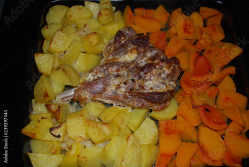 The drumstick of a Turkey with potatoes and pumpkin.