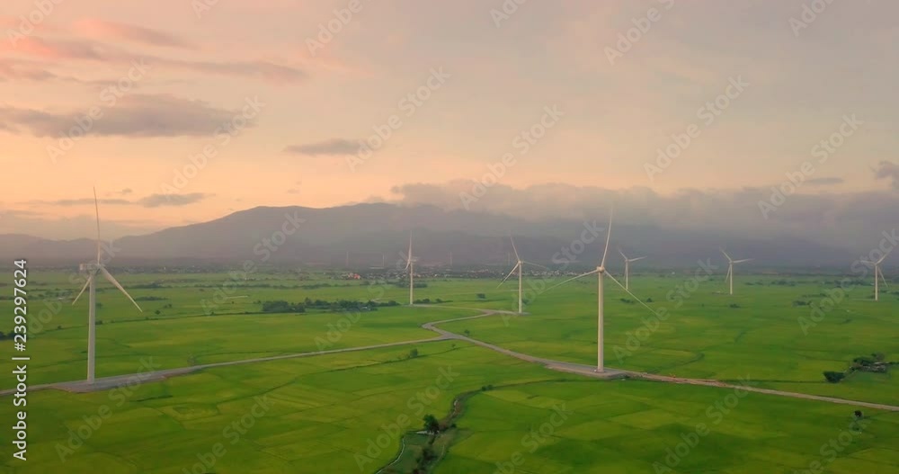 Wind turbine farm or windmill on golden sunset sky in summer day. High-quality stock photo image of wind turbine or windmill for clean energy concept. Energy Production with clean and Renewable Energy Wind turbine farm or windmill on golden sunset sky in summer day. High-quality stock photo image of wind turbine or windmill for clean energy concept. Energy Production with clean and Renewable Energy