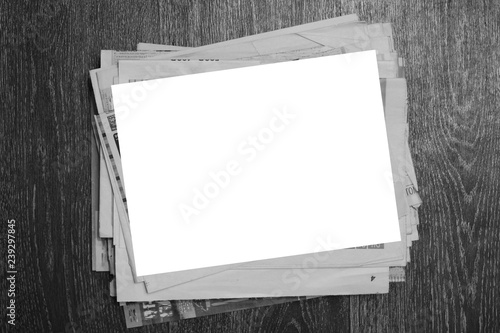 Stack of Newspapers and Magazines on Wooden Table. Business Journals with News and Blank Piece of Paper,  Top View, Media Template with Copy Space