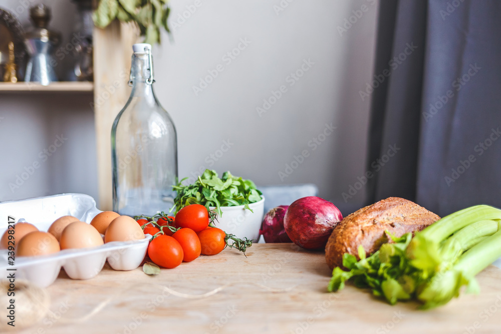 ingredients for salad, fresh vegetables, olive oil on the table in the kitchen. culinary and food concept ingredients for salad, fresh vegetables, olive oil on the table in the kitchen. culinary and food concept
