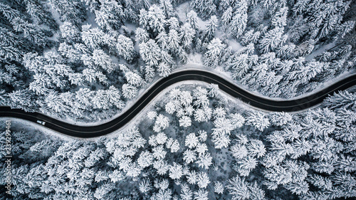 Driving in forest after snowfall, aerial drone view © marcin jucha