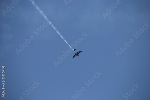 Small airplane doing aerial acrobatics in a exhibition