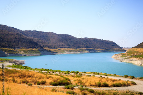 Beautiful view of the blue lake surrounded by mountains on the island of Cyprus © dolphinartin