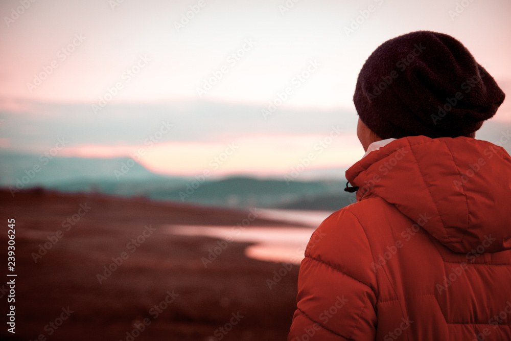 Girl looking at coral landscape with mountain and lake. Girl looking at coral landscape with mountain and lake.