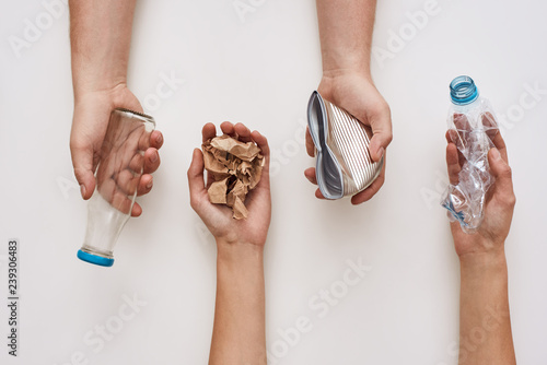 Foto Sparate your trash. Four types of garbage in human hands