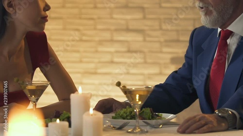 Young lady talking with old rich man, useful acquaintance, business partner