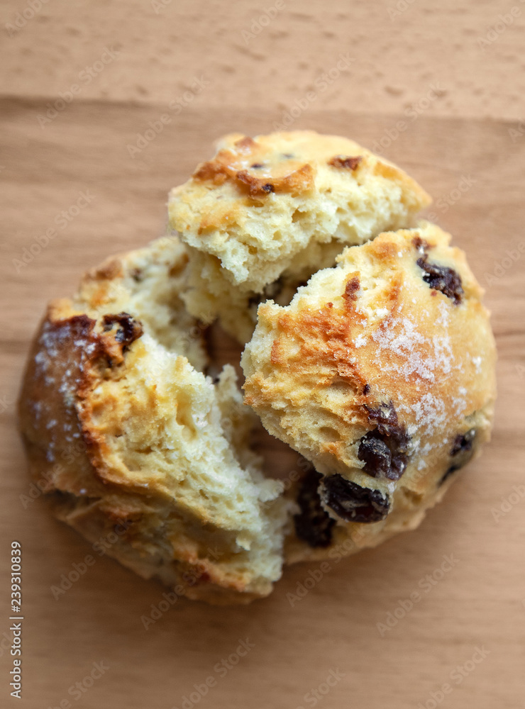 Bun with raisins on a wooden table. Bun with raisins on a wooden table.