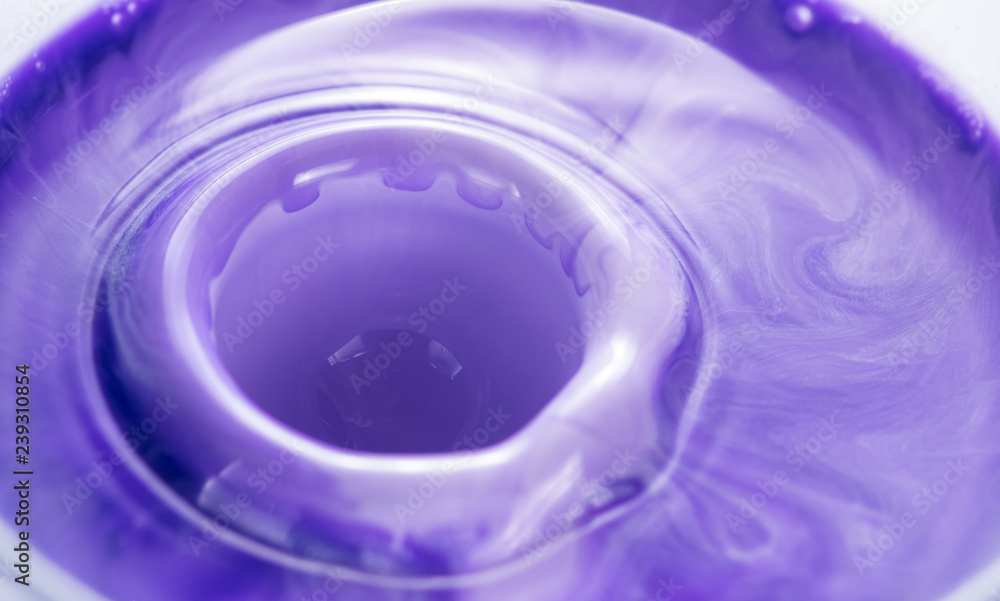 Fototapeta premium Mixing paints of different colors, drops and splashes close-up