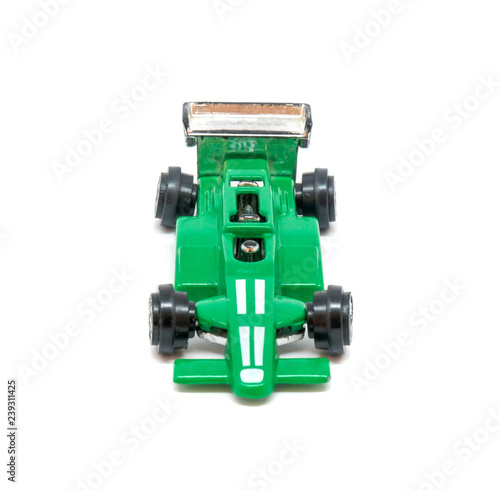 Photo of green toy model car isolated on white background