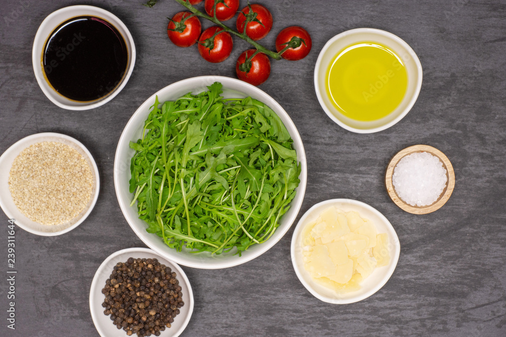 List of ingredients. recipe step by step arugula salad flatlay on grey stone List of ingredients. recipe step by step arugula salad flatlay on grey stone
