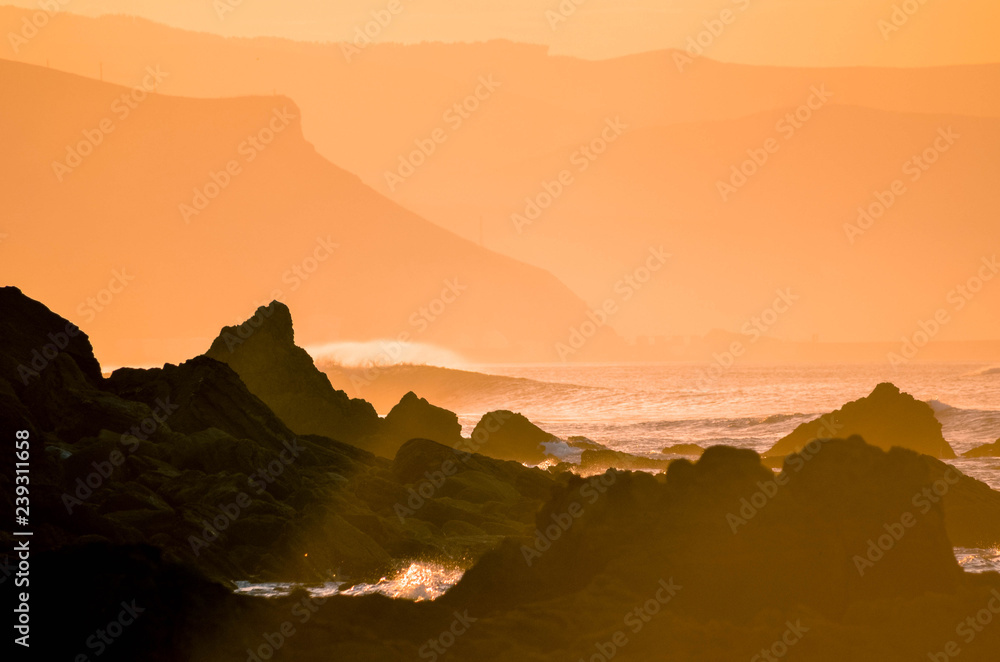 Spectacular sunset on the coast with orange tones