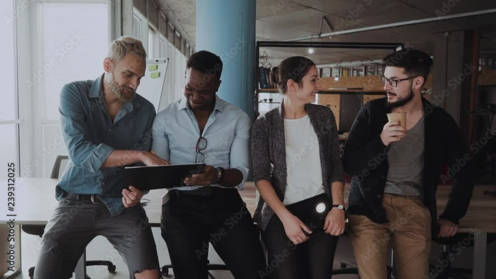 office workers are friendly, they are dressed in a watch room, an international team, a meeting of employees