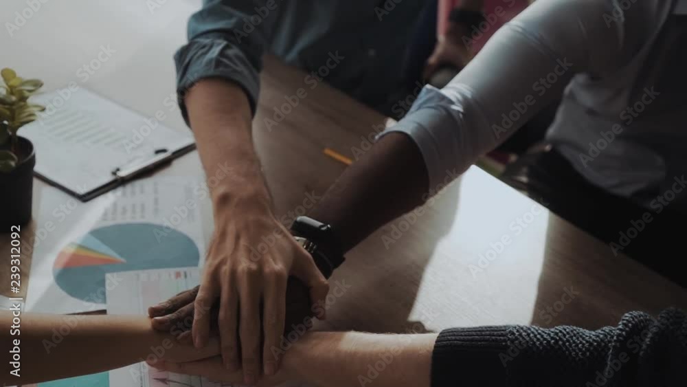 Close up top view of young business people putting their hands together. Stack of hands. Unity and teamwork concept. Close up top view of young business people putting their hands together. Stack of hands. Unity and teamwork concept.