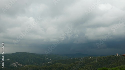 Lightning flash on cloydy sky over hills, Baecelona