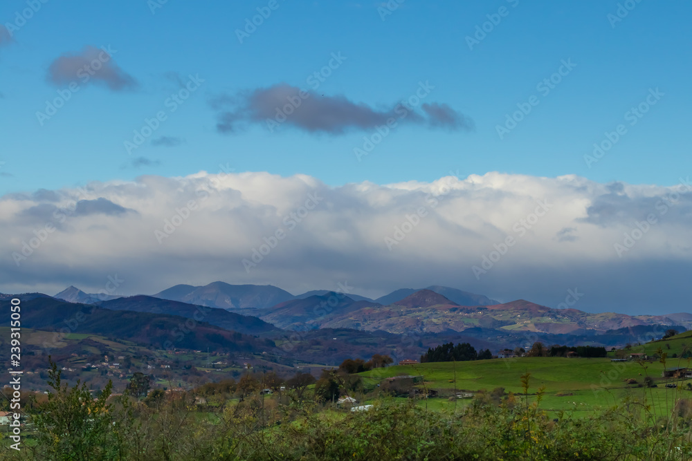 Fototapeta premium Mountain range in clear weather in contrasting rain clouds before the rain