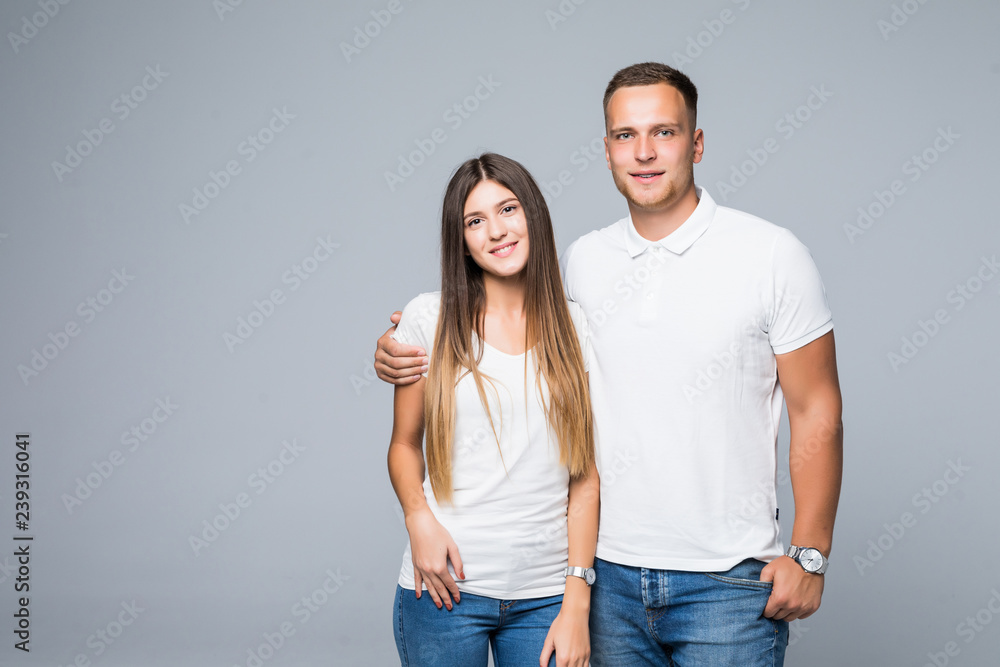 Portrait of happy couple looking at camera on gray background Portrait of happy couple looking at camera on gray background