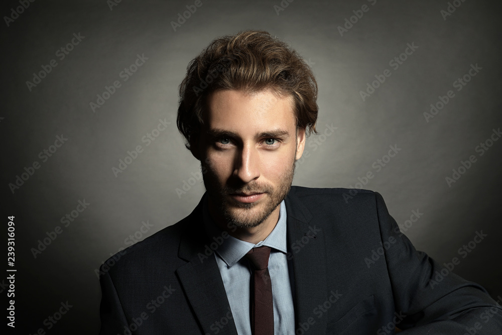 Portrait of young handsome businessman on black background Portrait of young handsome businessman on black background