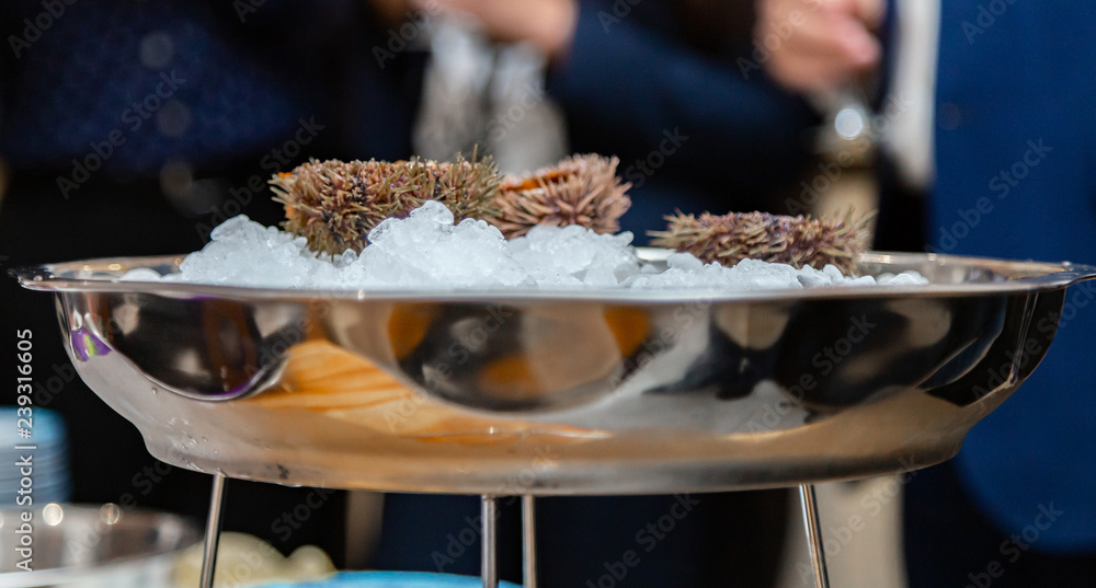 People eat sea urchin in a restaurant